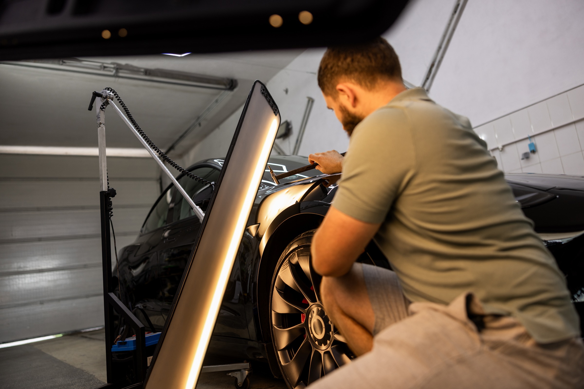 Restoring black body dents with precision tools during paintless dent repair